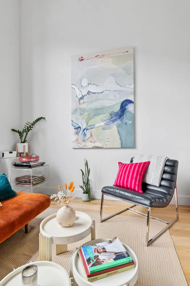 a living room with furniture and a lamp