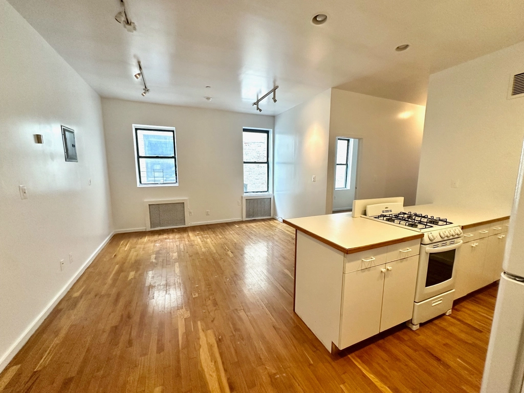 500 West 148th Street, Unit 5C Manhattan, NY 10031 - Photo 2 of 5 a kitchen with wooden floor and sink