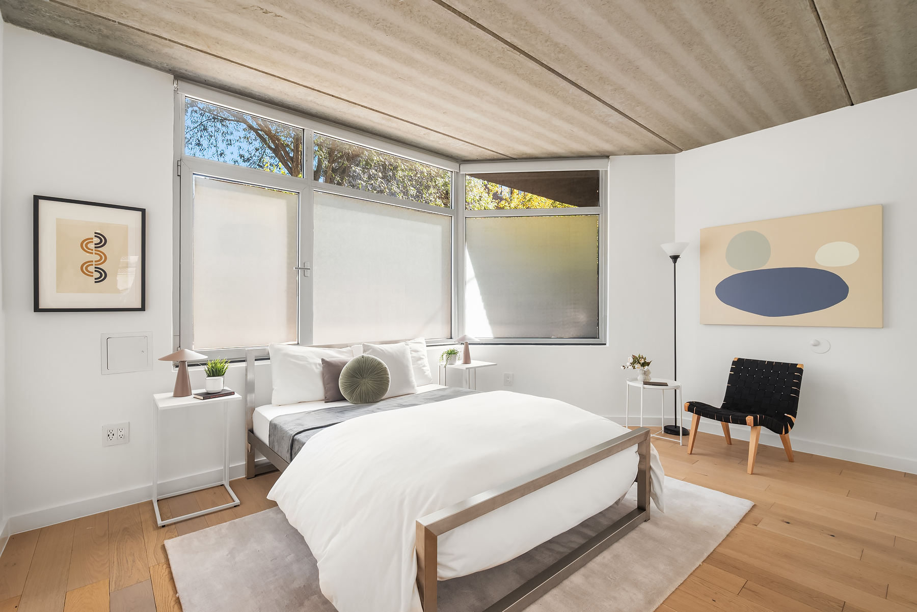 a bedroom with bed and a large window