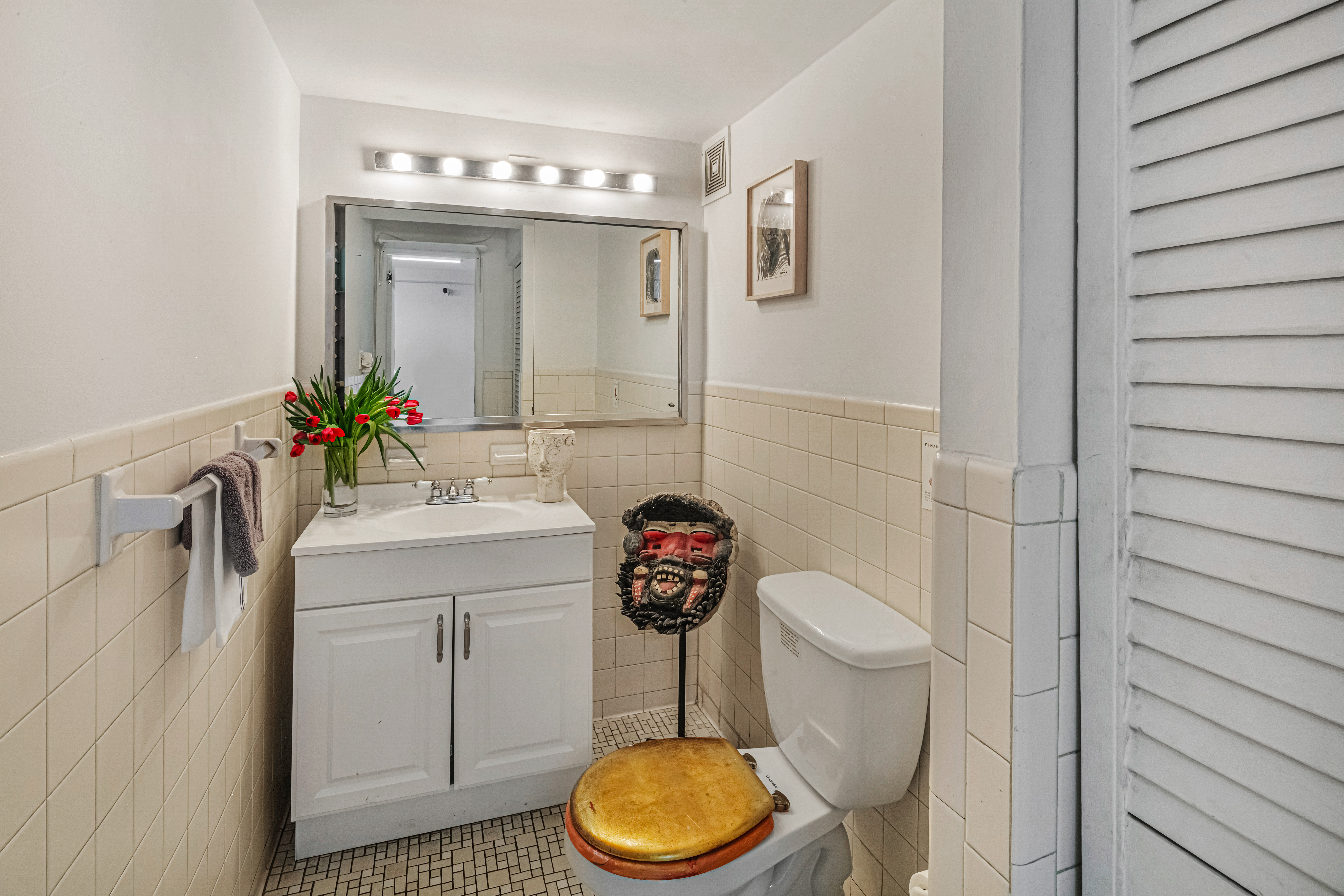 251 West 19th Street, Unit 1G Manhattan, NY 10011 - Photo 13 of 31 a bathroom with a toilet a sink and a mirror