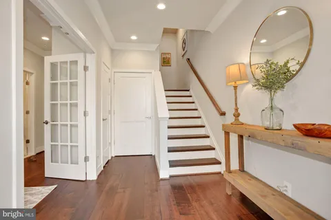 a view of entryway and hall with wooden floor