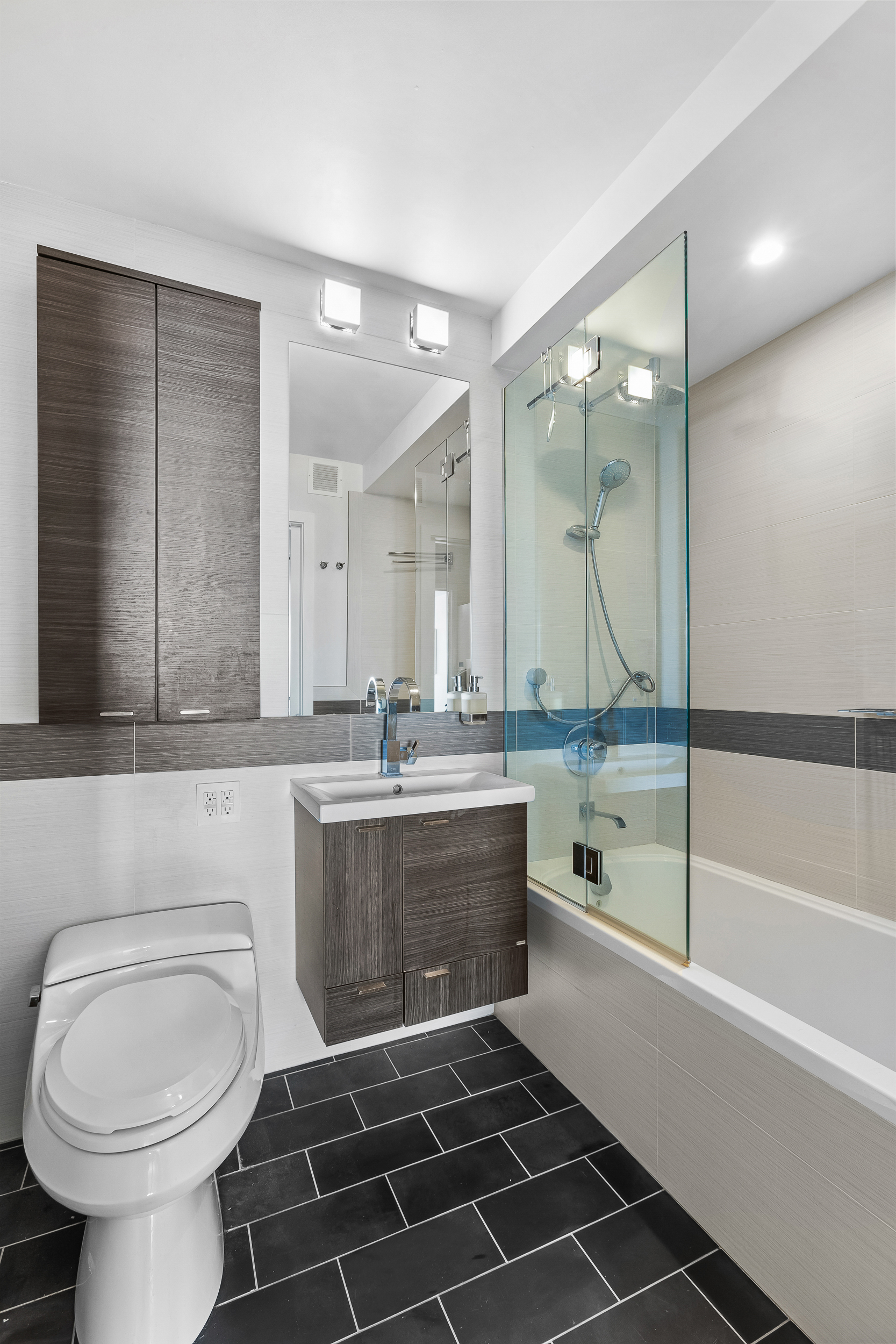 376 Broadway, Unit 14E Manhattan, NY 10013 - Photo 10 of 11 a bathroom with a sink toilet and shower