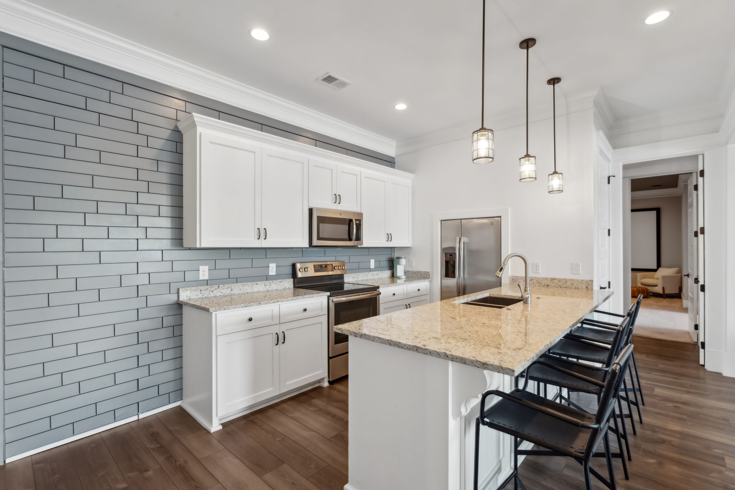 249 Pointe Overlook Drive Chapin, SC 29036 - Photo 26 of 56 a kitchen with stainless steel appliances a stove a sink a microwave a center island and a wooden floor