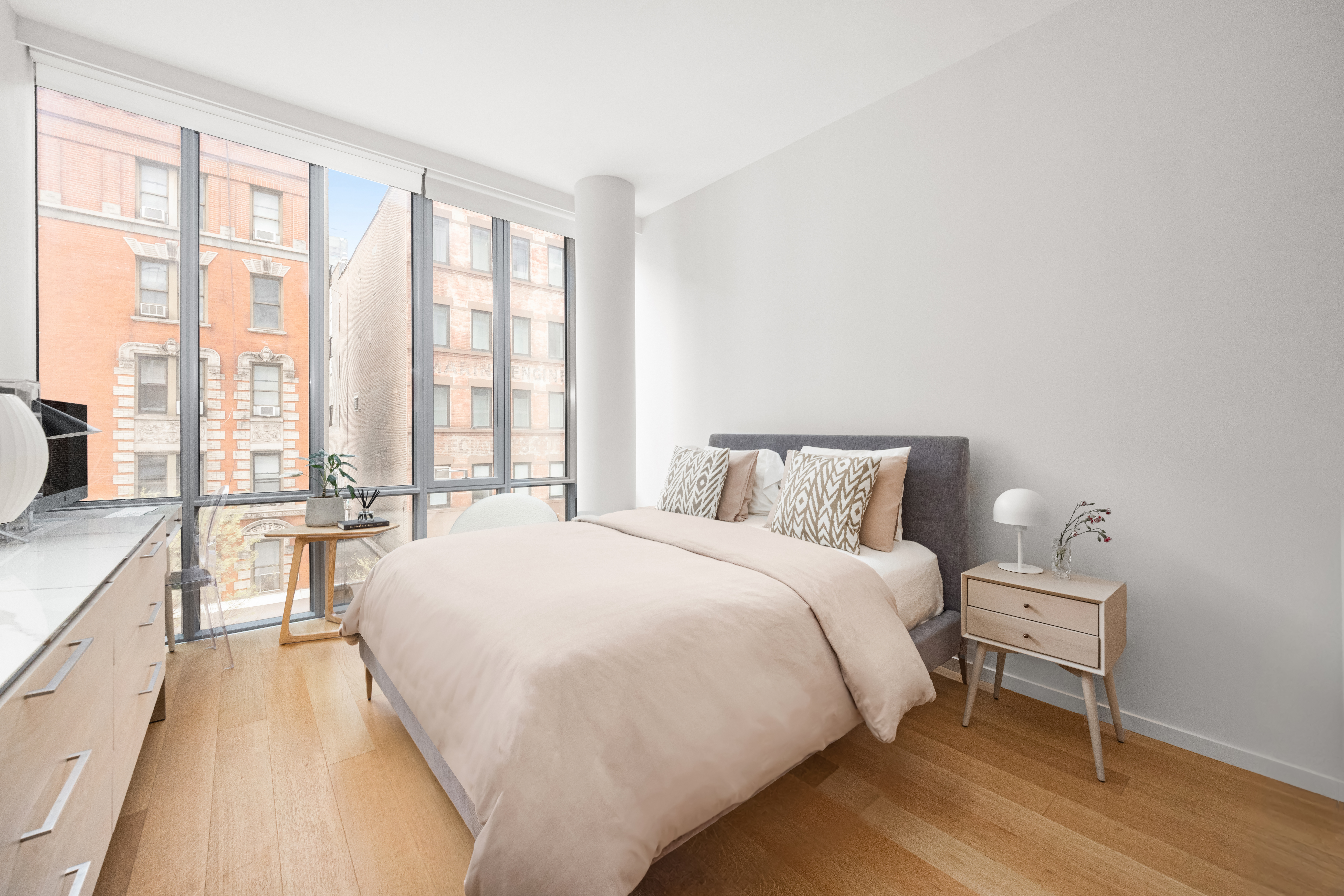 565 Broome Street, Unit N5E Manhattan, NY 10013 - Photo 5 of 16 a large bed sitting in a bedroom next to a window