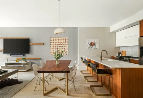 a reading room with furniture a flat screen tv and a window