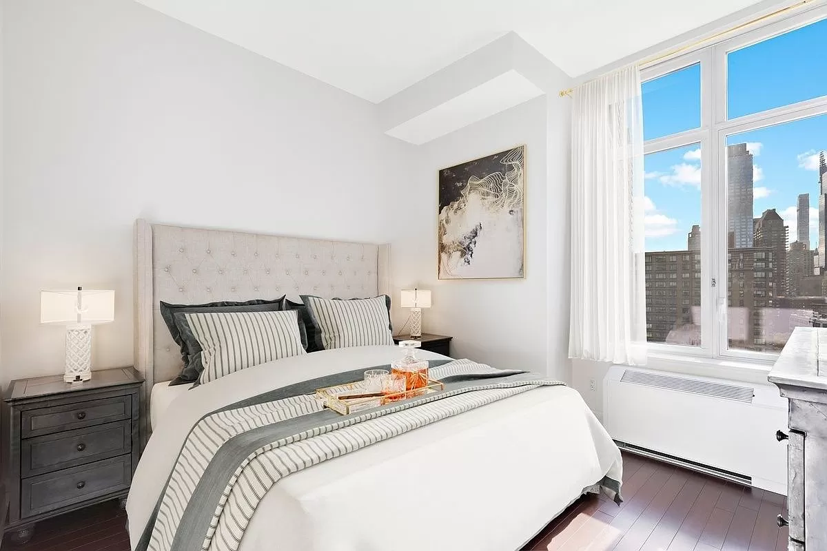 a bedroom with a large bed and a window