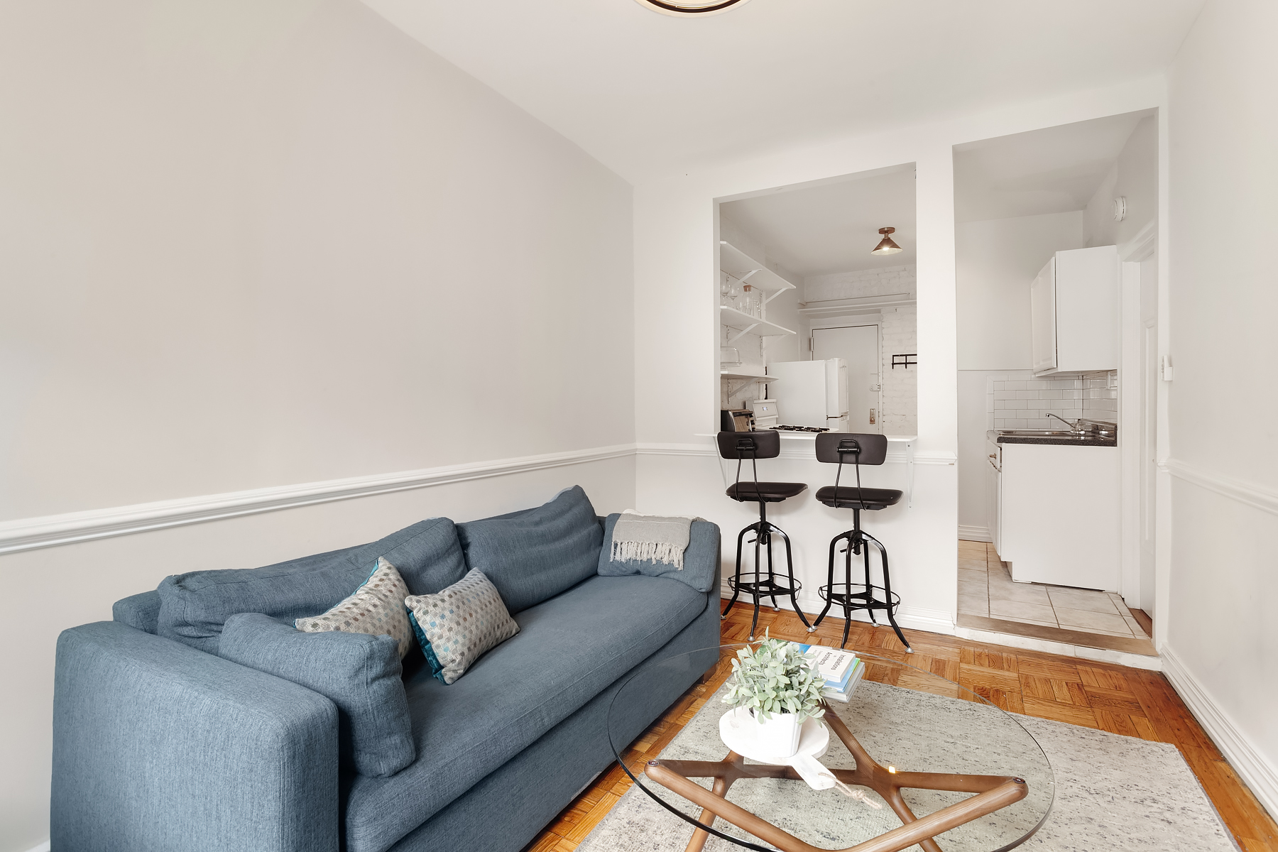 181 Thompson Street, Unit 19 Manhattan, NY 10012 - Photo 2 of 7 a living room with furniture and a wooden floor