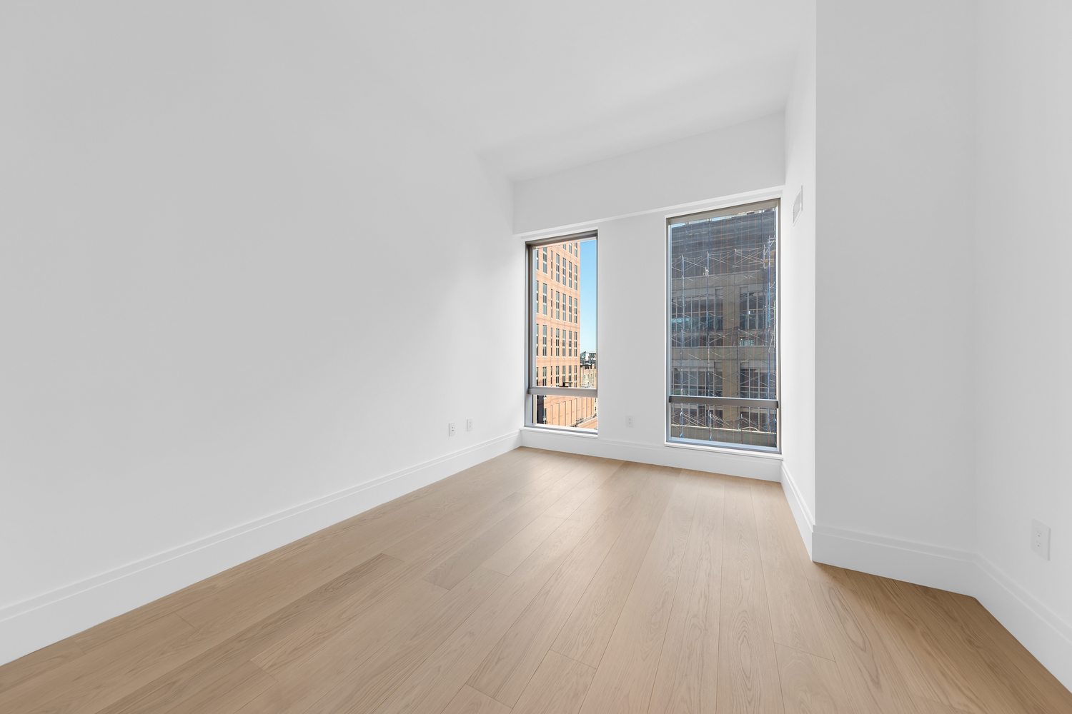 50 West 66th Street, Unit 17A Manhattan, NY 10023 - Photo 15 of 49 an empty room with wooden floor and windows
