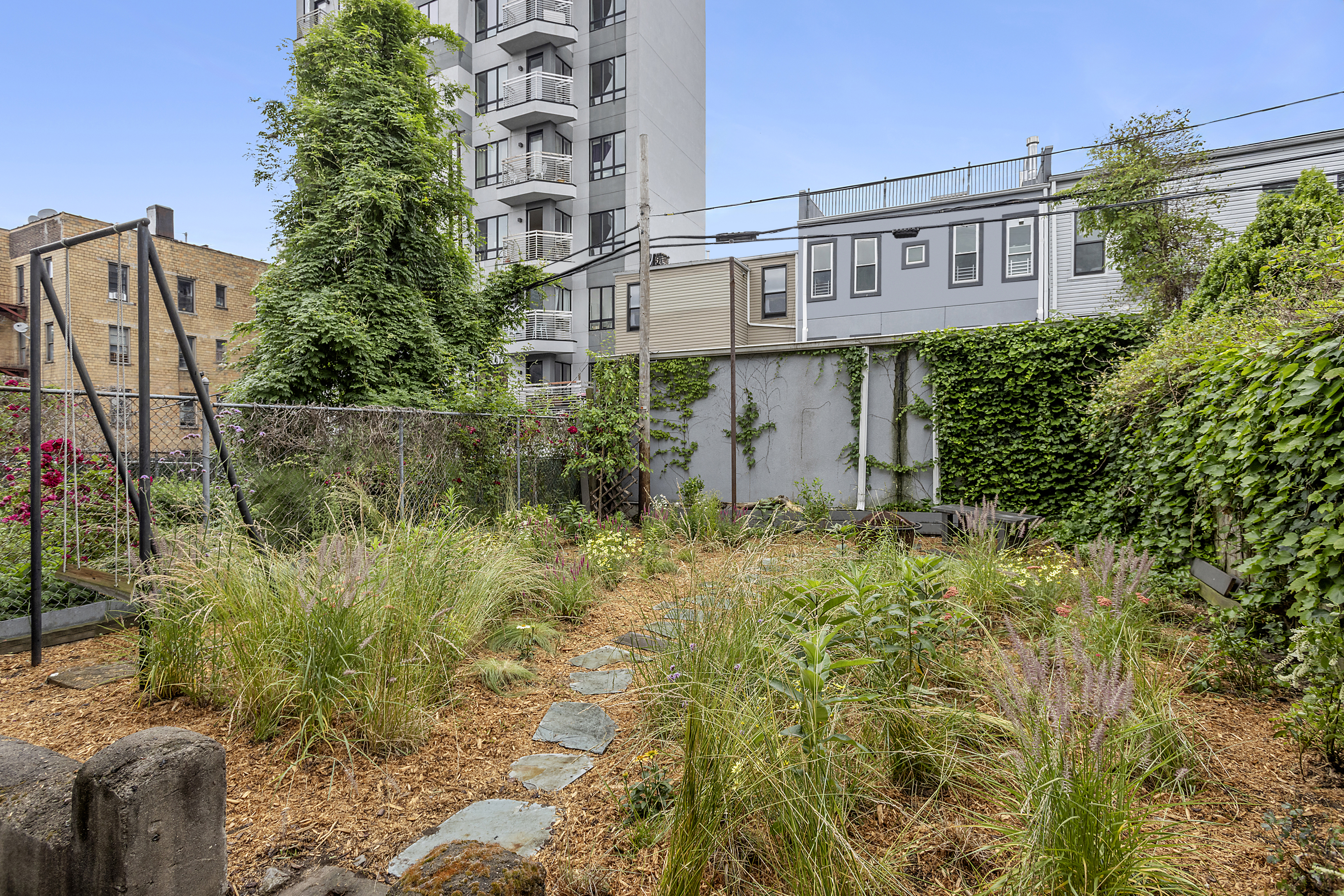 768 Hart Street, Unit 1 Brooklyn, NY 11237 - Photo 15 of 18 a view of a house with a yard