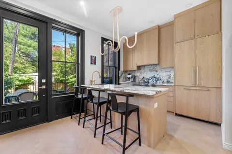a kitchen with a table chairs sink and cabinets