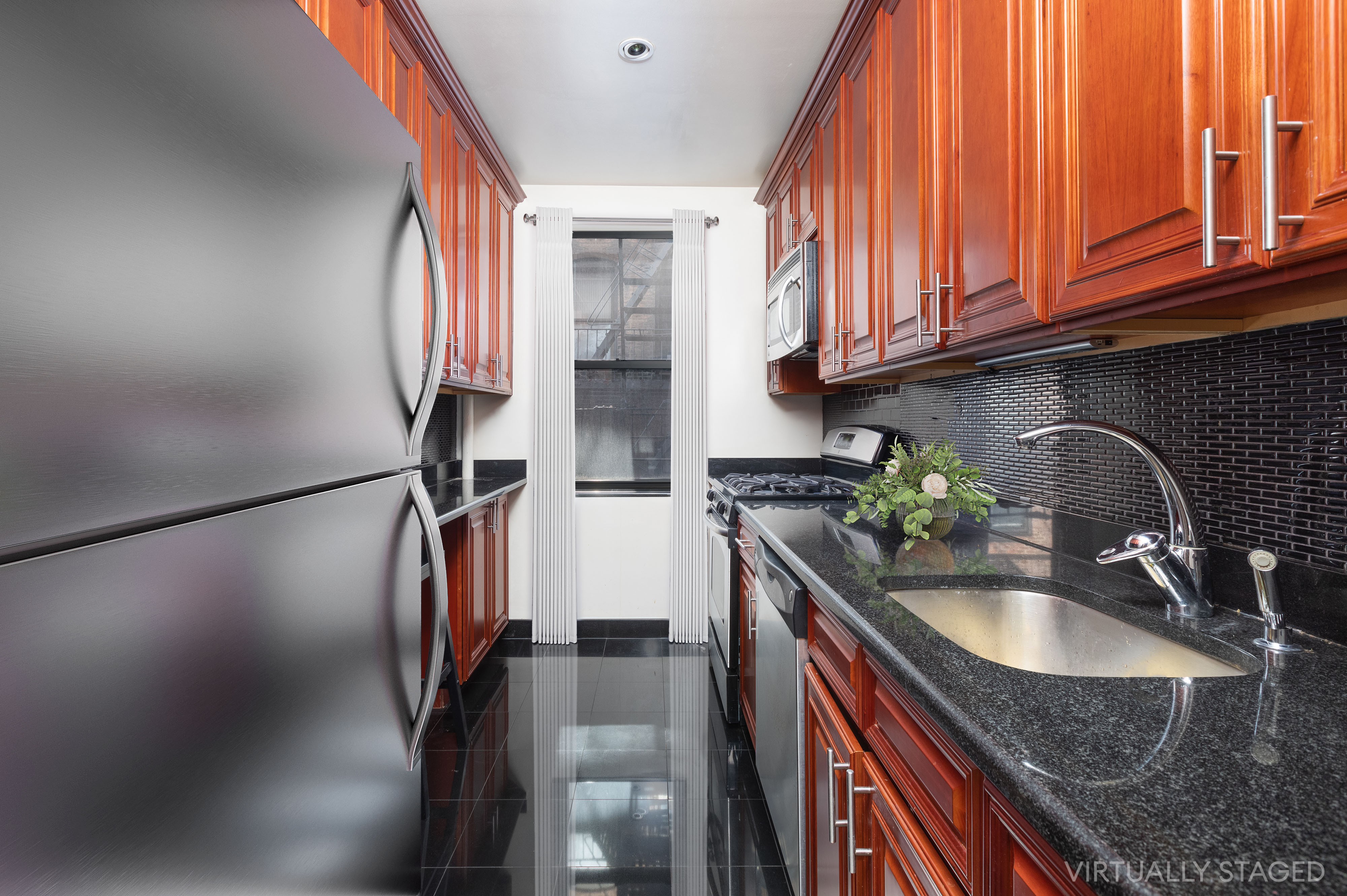 402 East 74th Street, Unit 4B Manhattan, NY 10021 - Photo 6 of 9 a kitchen with stainless steel appliances granite countertop a sink refrigerator stove and microwave
