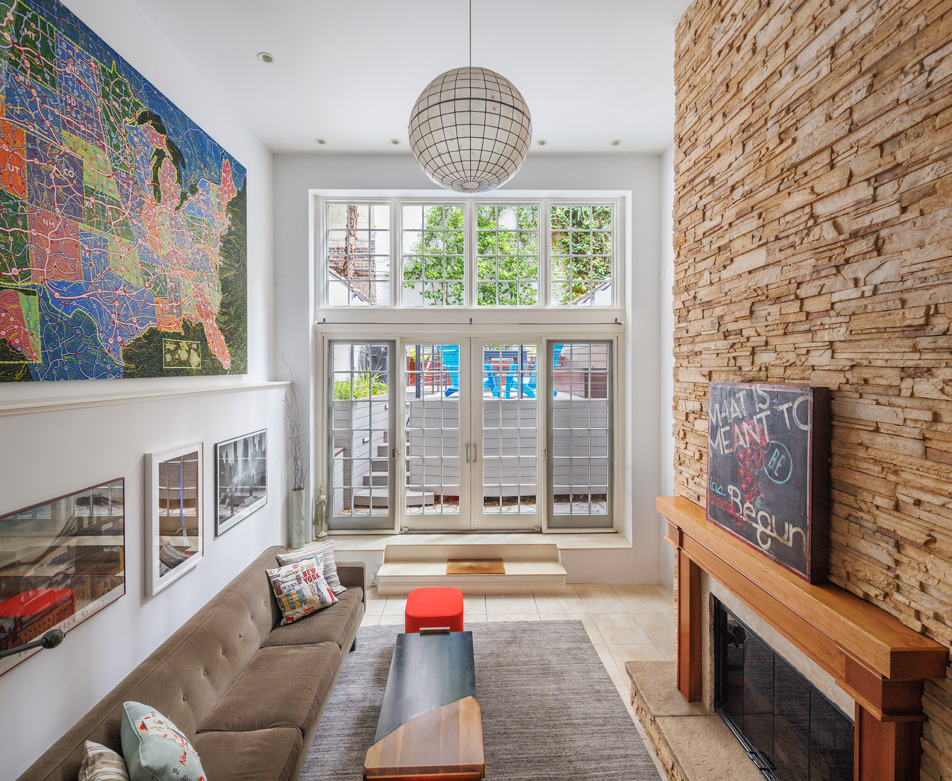217 West 22nd Street Manhattan, NY 10011 - Photo 1 of 16 a living room with furniture and a floor to ceiling window