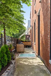 a view of a patio with table and chairs and potted plants