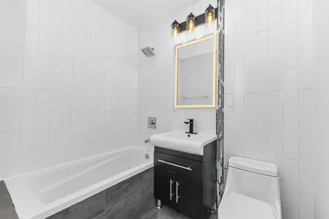 a bathroom with a sink a toilet and vanity