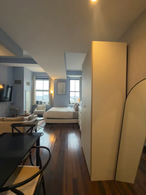 a view of a livingroom with furniture and a window