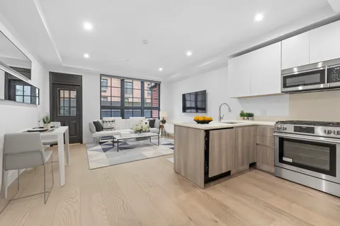 a kitchen with sink cabinets and stainless steel appliances