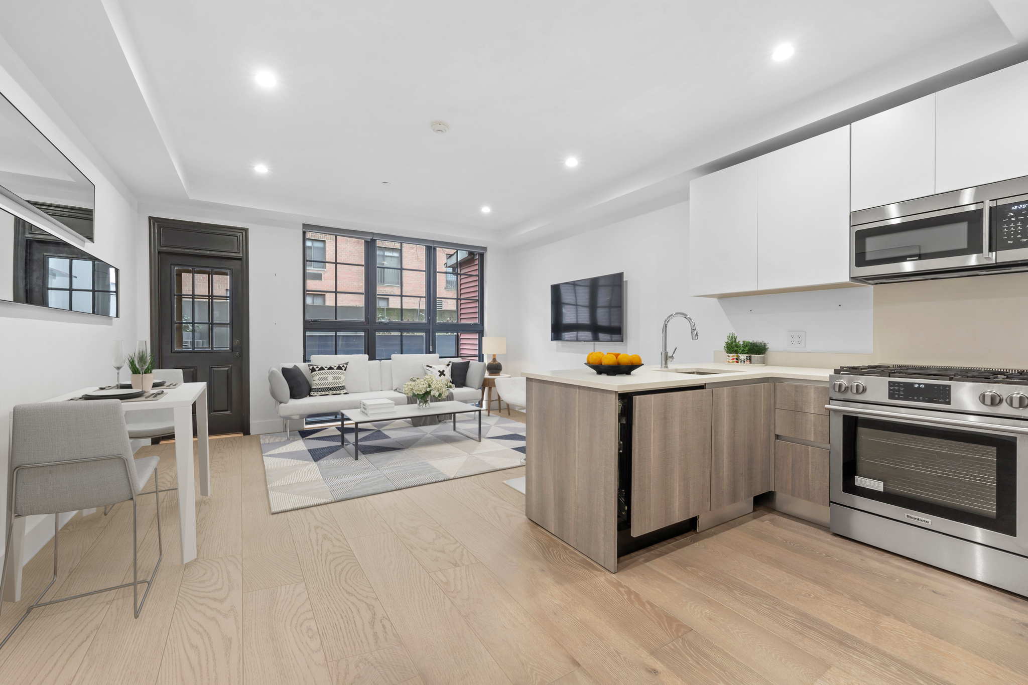 440 West 20th Street Manhattan, NY 10011 - Photo 23 of 35 a kitchen with sink cabinets and stainless steel appliances