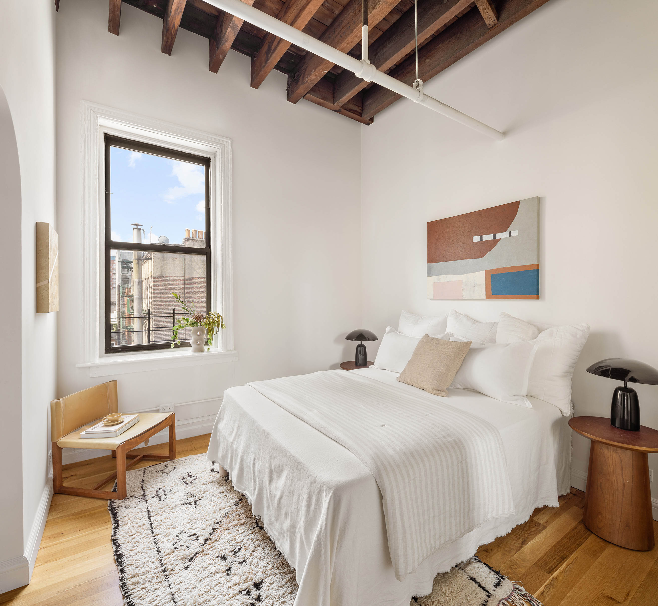84 Forsyth Street, Unit 5R Manhattan, NY 10002 - Photo 8 of 14 a bedroom with a bed and wooden floor
