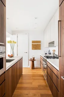 a kitchen with a sink and wooden cabinets