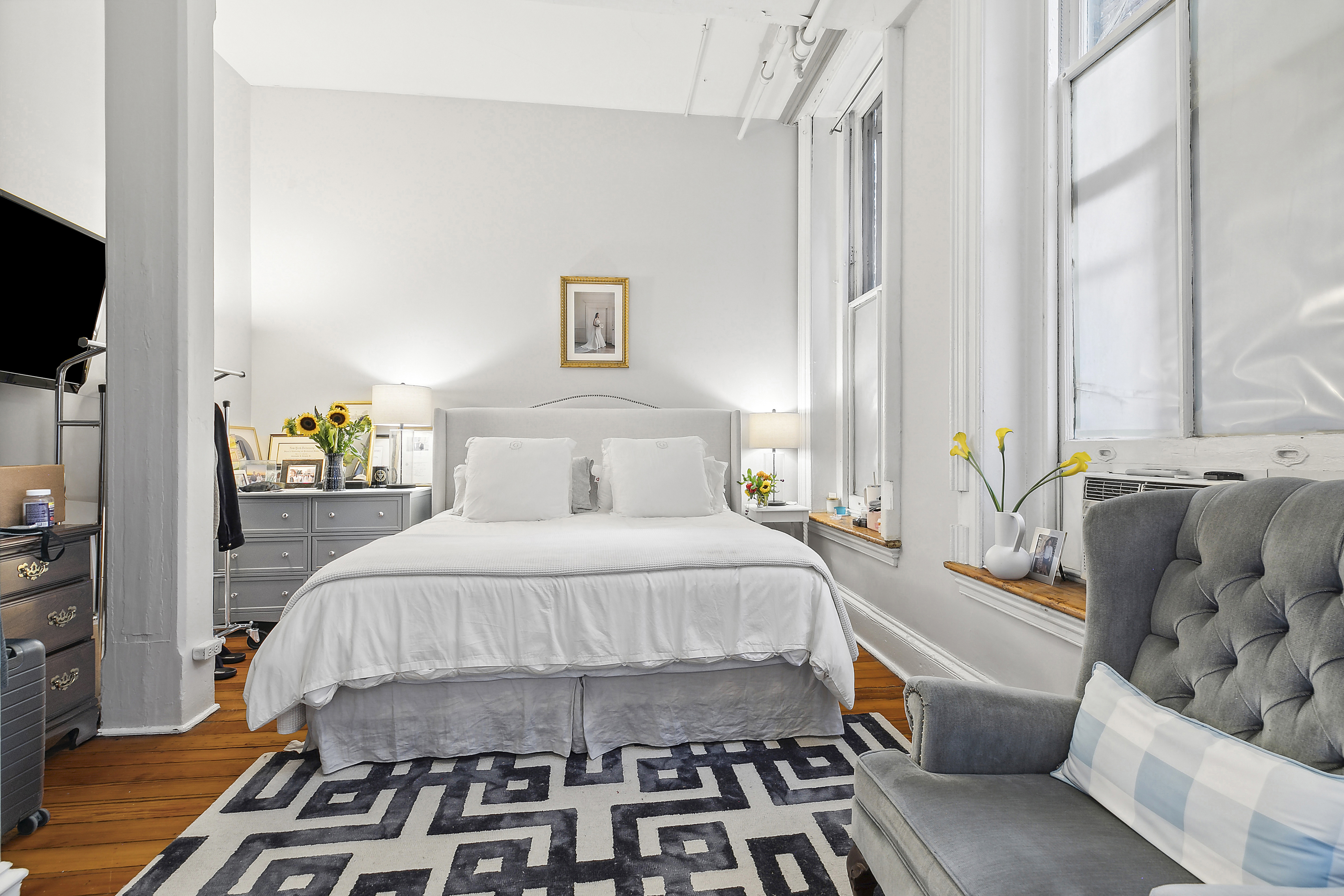 116 Franklin Street, Unit 3 Manhattan, NY 10013 - Photo 2 of 9 a bedroom with a bed and a couch