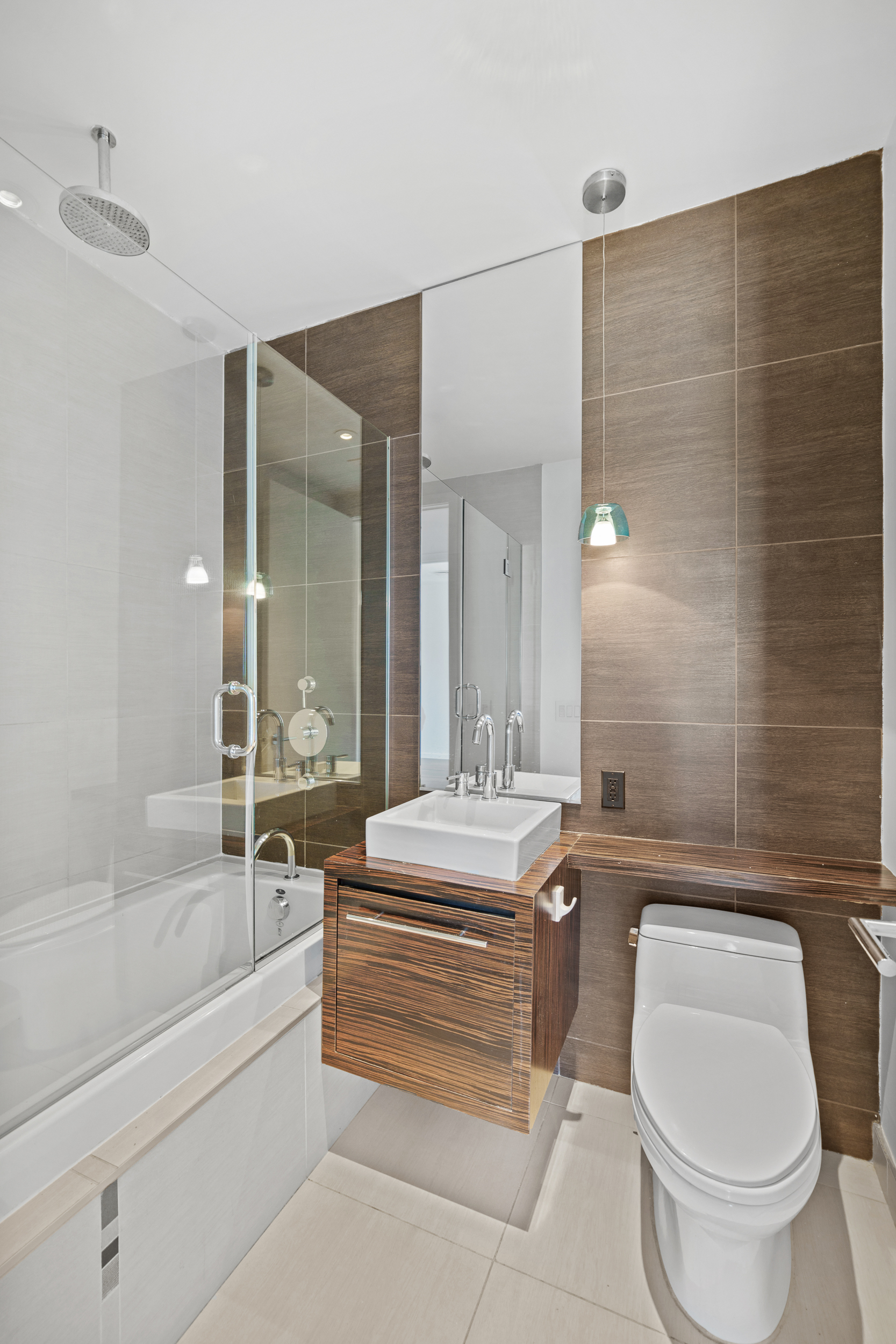 170 North 11th Street, Unit 5B Brooklyn, NY 11211 - Photo 8 of 11 a bathroom with a granite countertop toilet a sink and bathtub