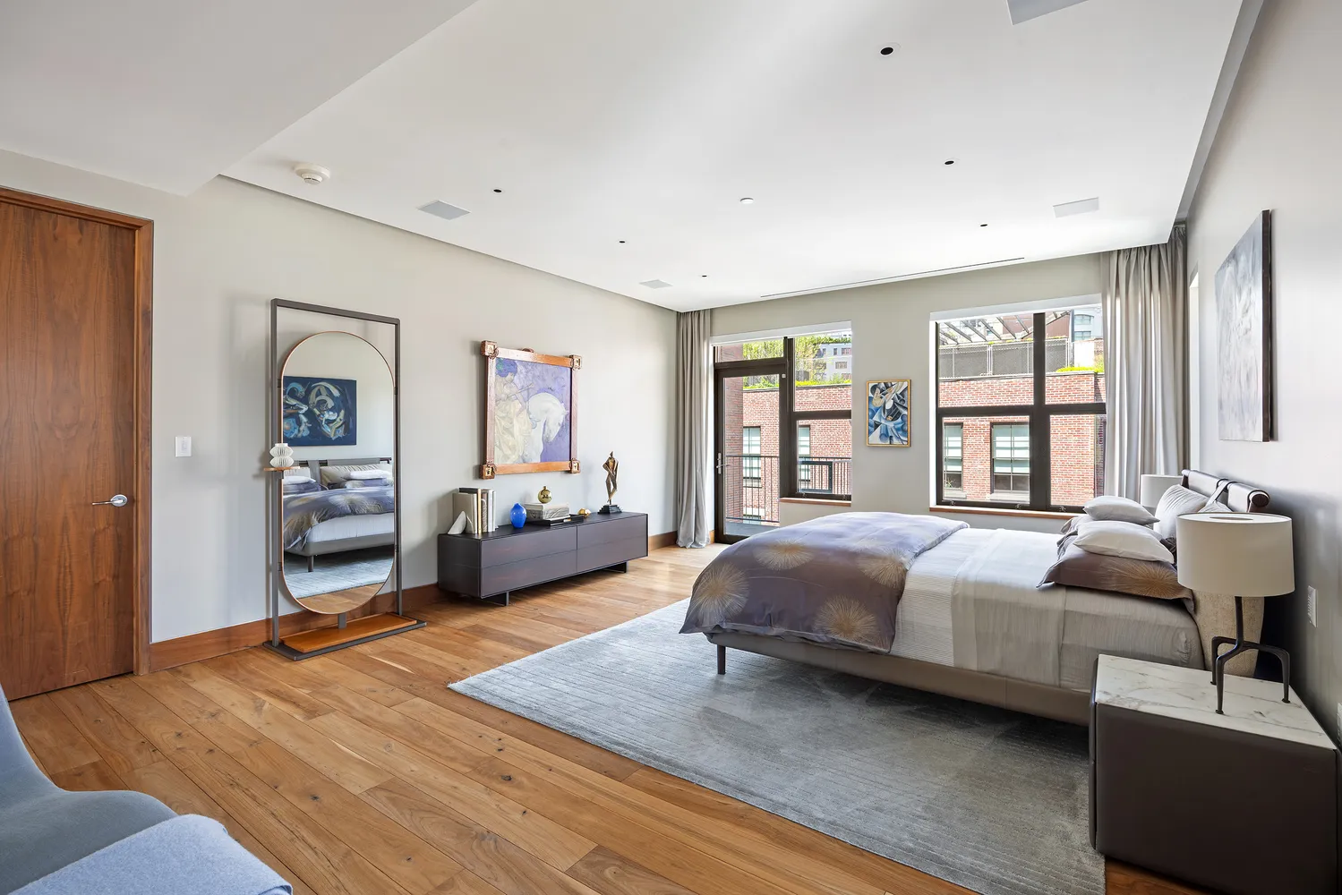 a bedroom with a large bed and a large window