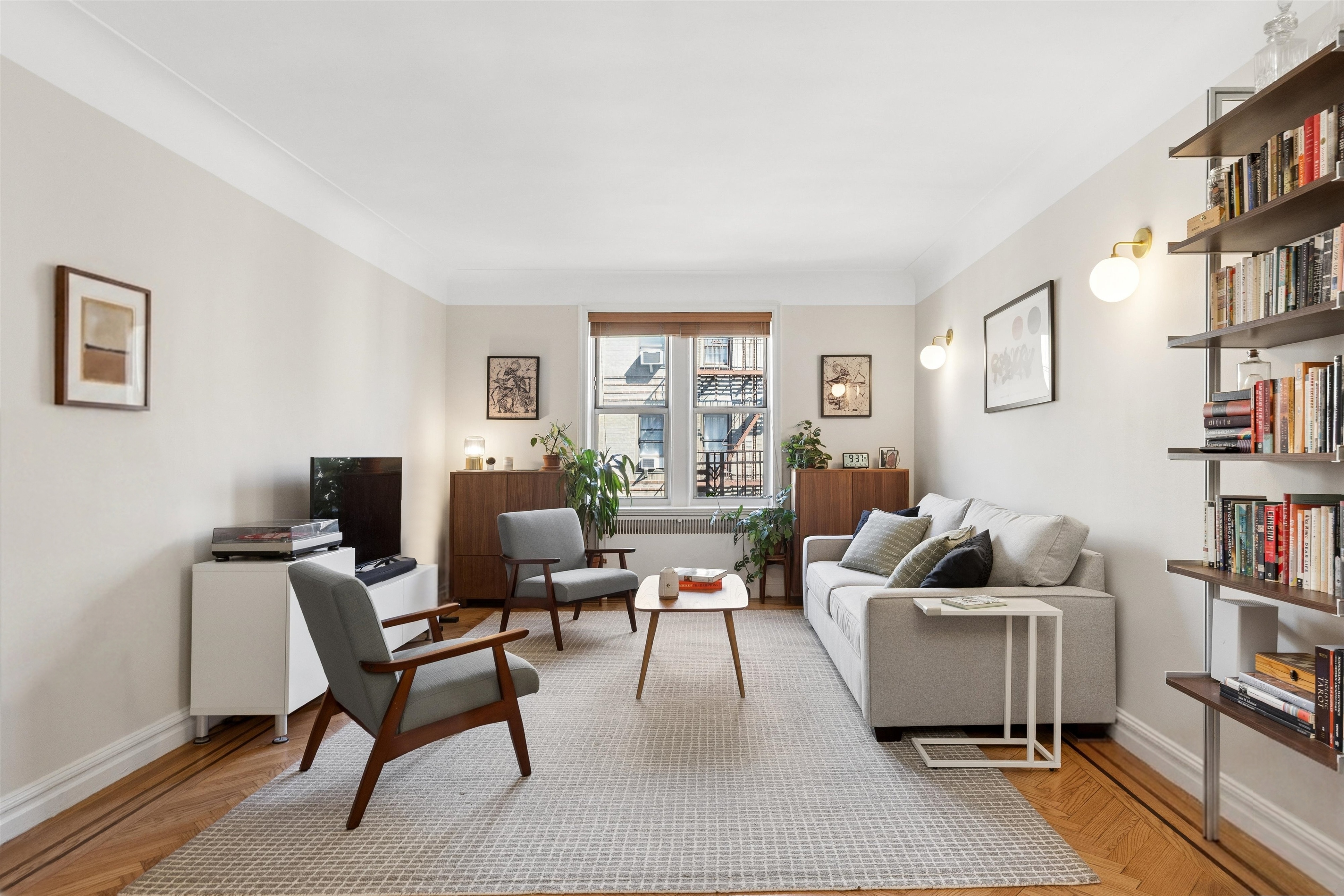 a living room with furniture and a book shelf