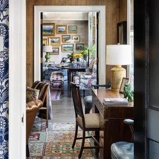 a dining room with furniture and a floor to ceiling window
