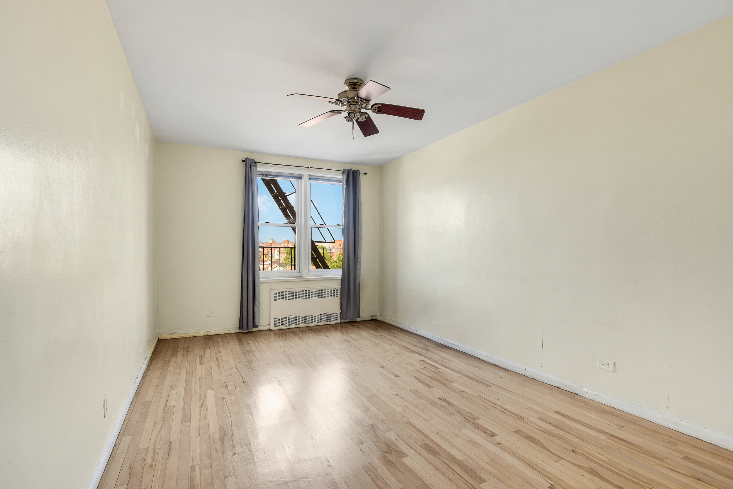 9801 Shore Road, Unit 4P Brooklyn, NY 11209 - Photo 8 of 13 a view of a room with wooden floor staircase and a ceiling fan