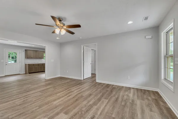 wooden floor in an empty room with a window