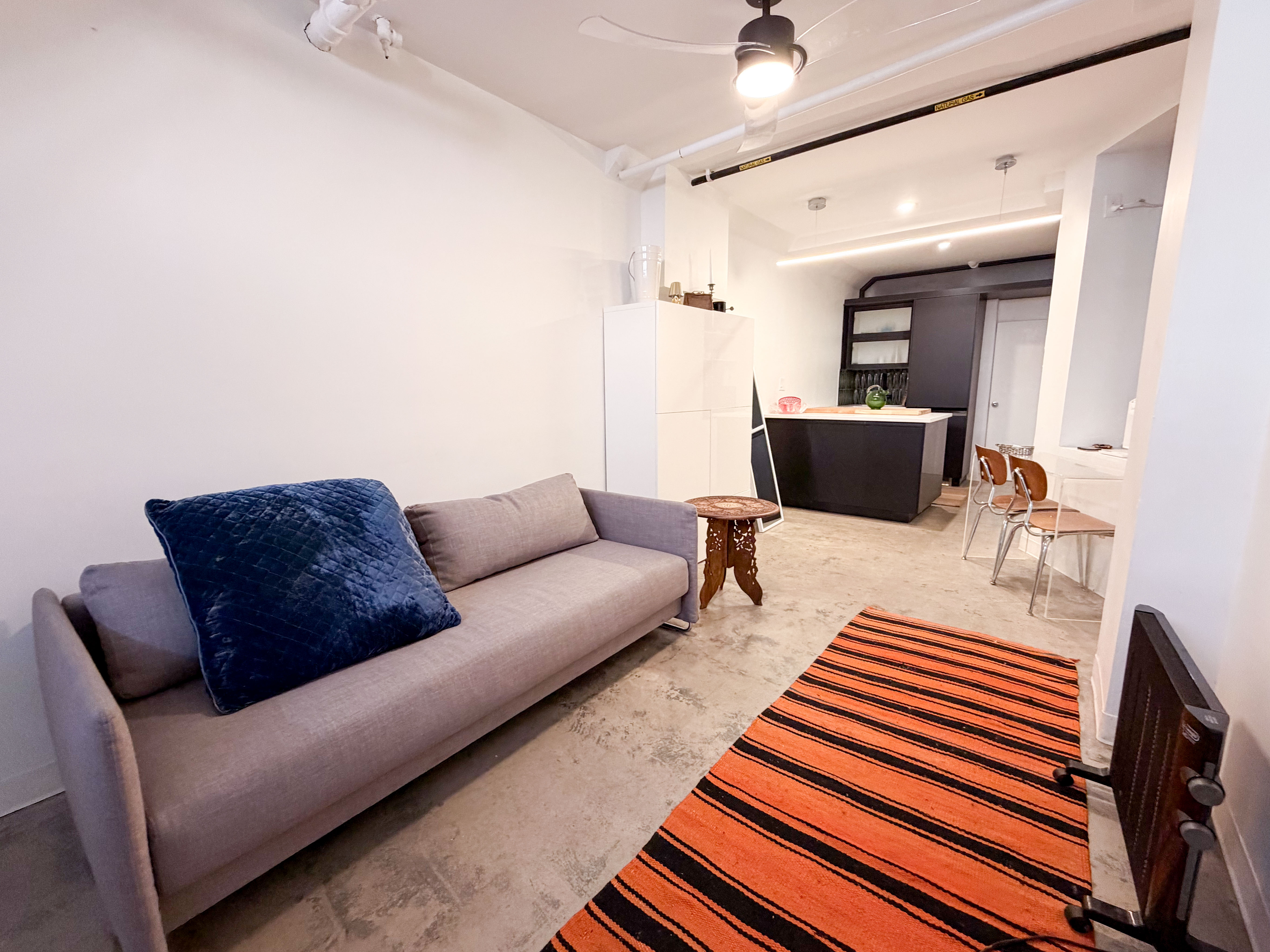 206 East 7th Street, Unit G Manhattan, NY 10009 - Photo 2 of 22 a living room with furniture and a rug