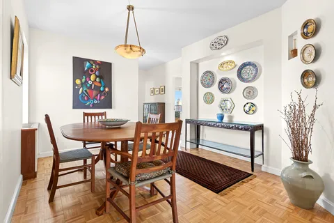 a view of a dining room with furniture and a chandelier