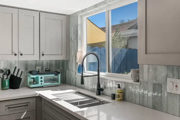 a kitchen with a sink and a refrigerator