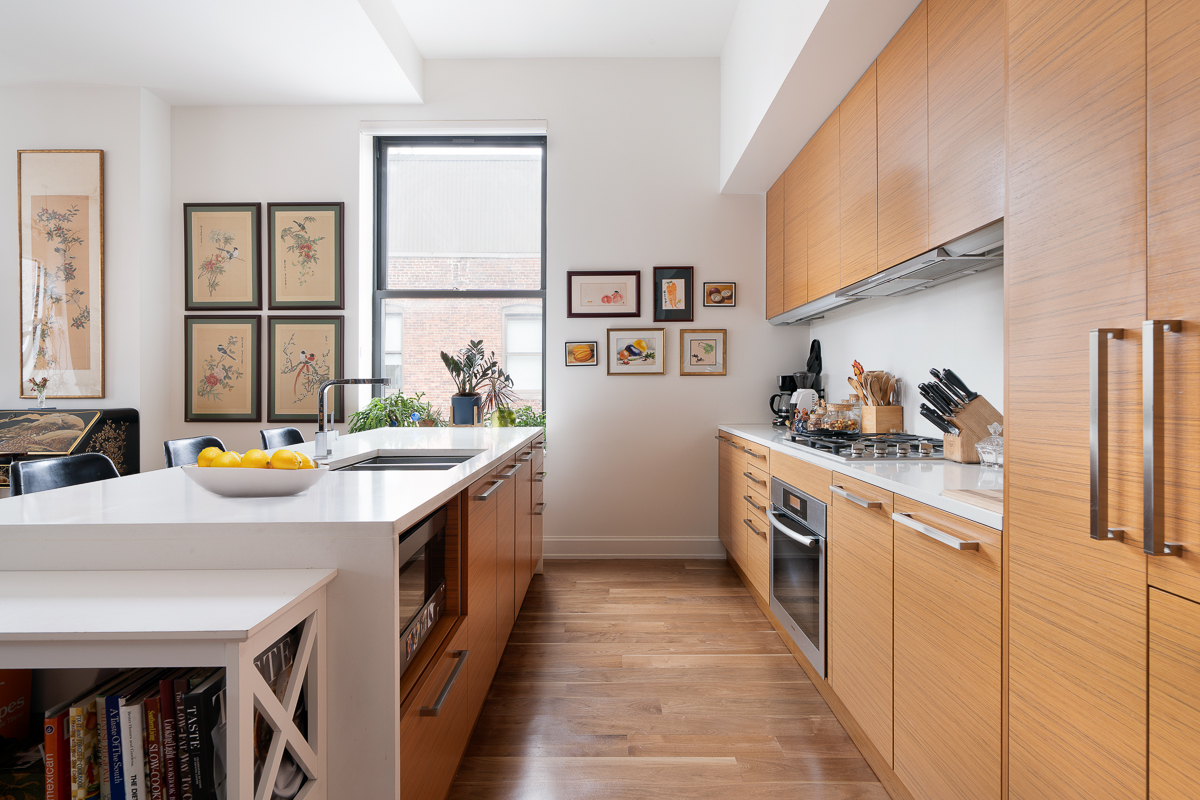 140 West 22nd Street, Unit PHC Manhattan, NY 10011 - Photo 3 of 15 a kitchen with stainless steel appliances granite countertop a sink and a stove