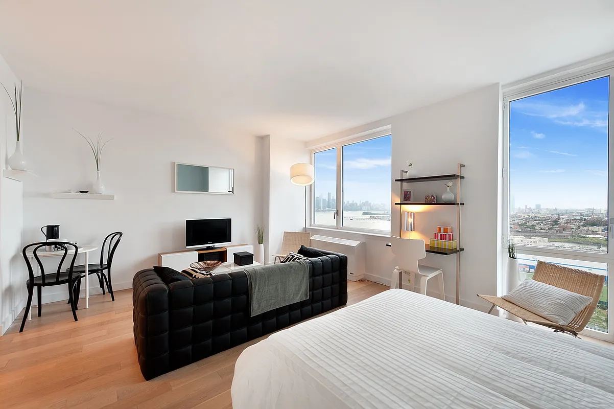 22 North 6th Street, Unit 23E Brooklyn, NY 11249 - Photo 2 of 10 a bedroom with a bed and a couch