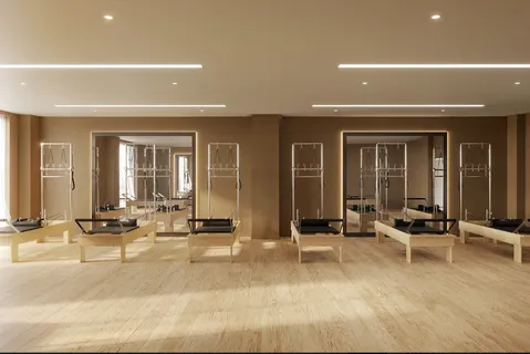 a view of a room with gym equipment and floor to ceiling windows