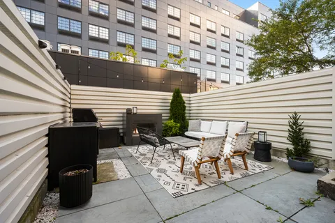 a view of a patio with table and chairs and potted plants