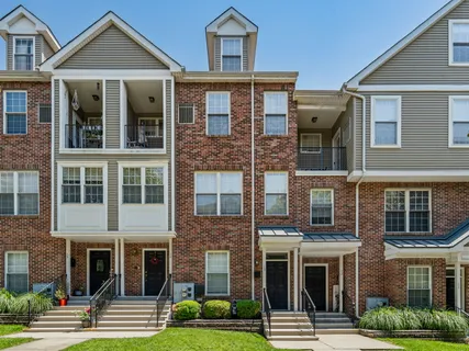 a front view of a residential apartment building with a yard