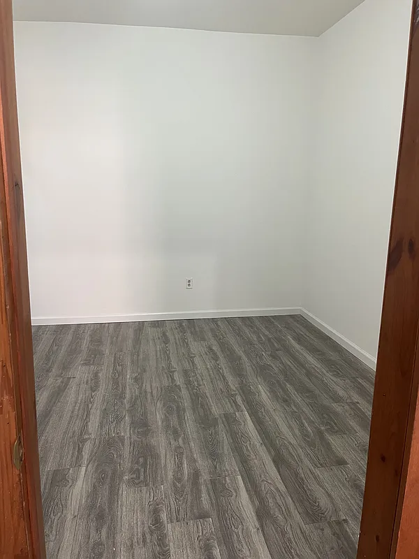 571 Nostrand Avenue, Unit 3R Brooklyn, NY 11216 - Photo 4 of 7 an empty room with wooden floor