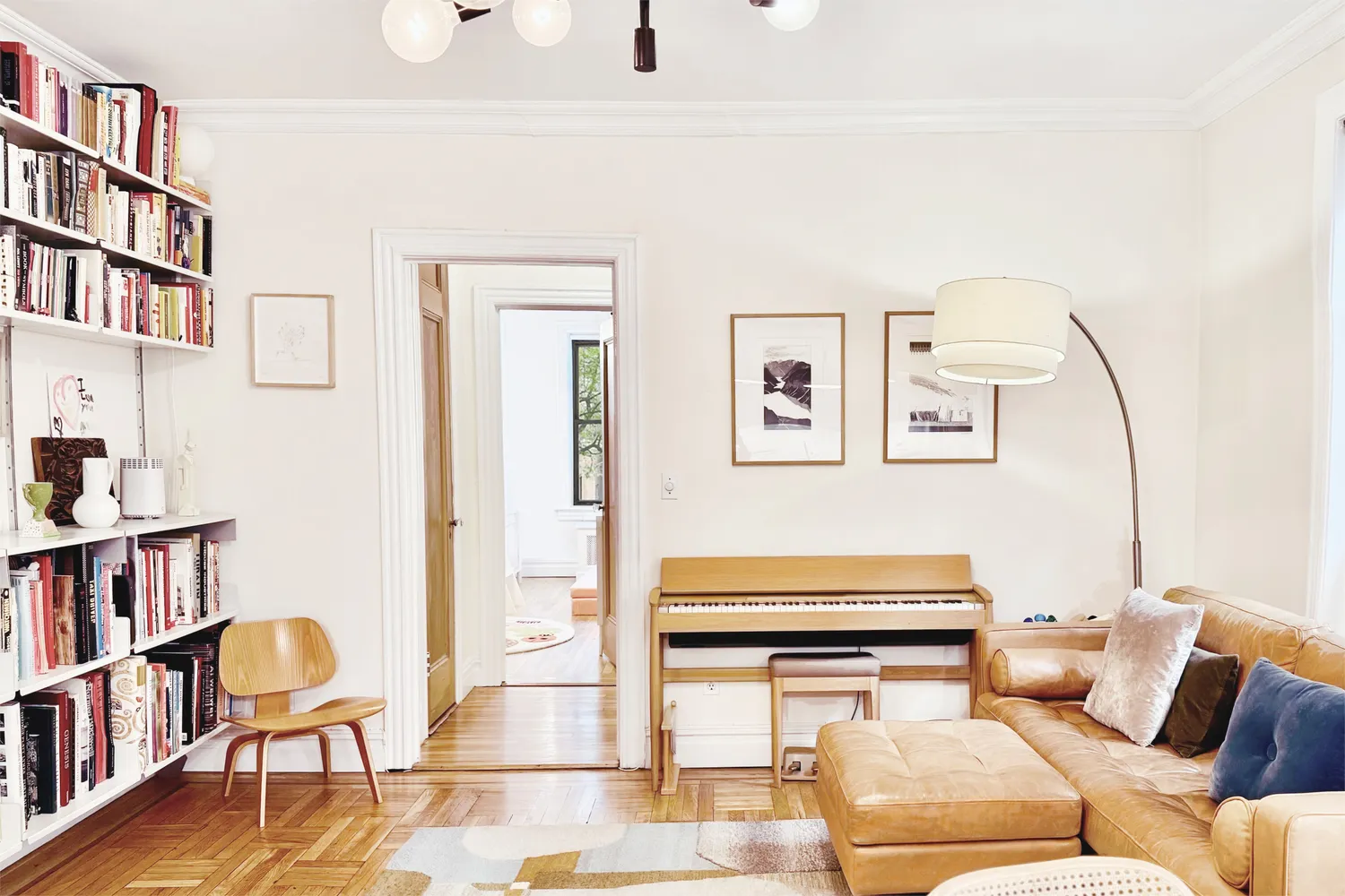 a living room with furniture a rug and a book shelf