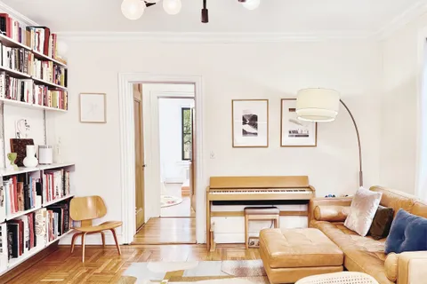 a living room with furniture a rug and a book shelf