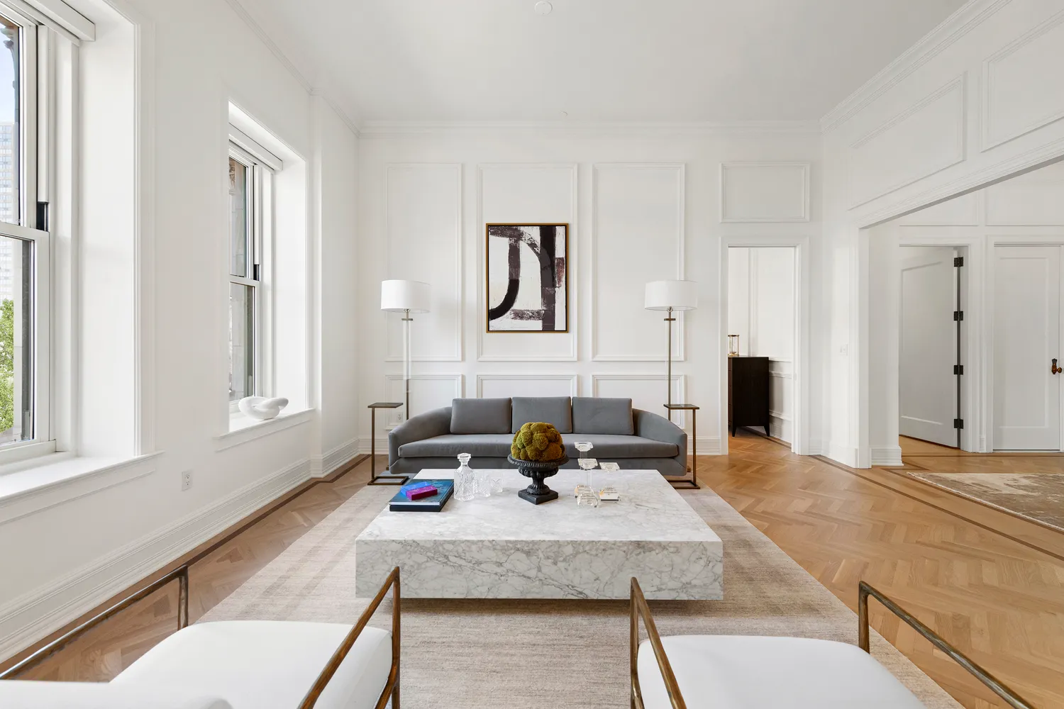 a spacious bedroom with a bed lamp and a large window