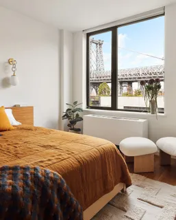 a bedroom with two beds and a large window