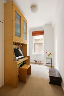 a bedroom with furniture and a window