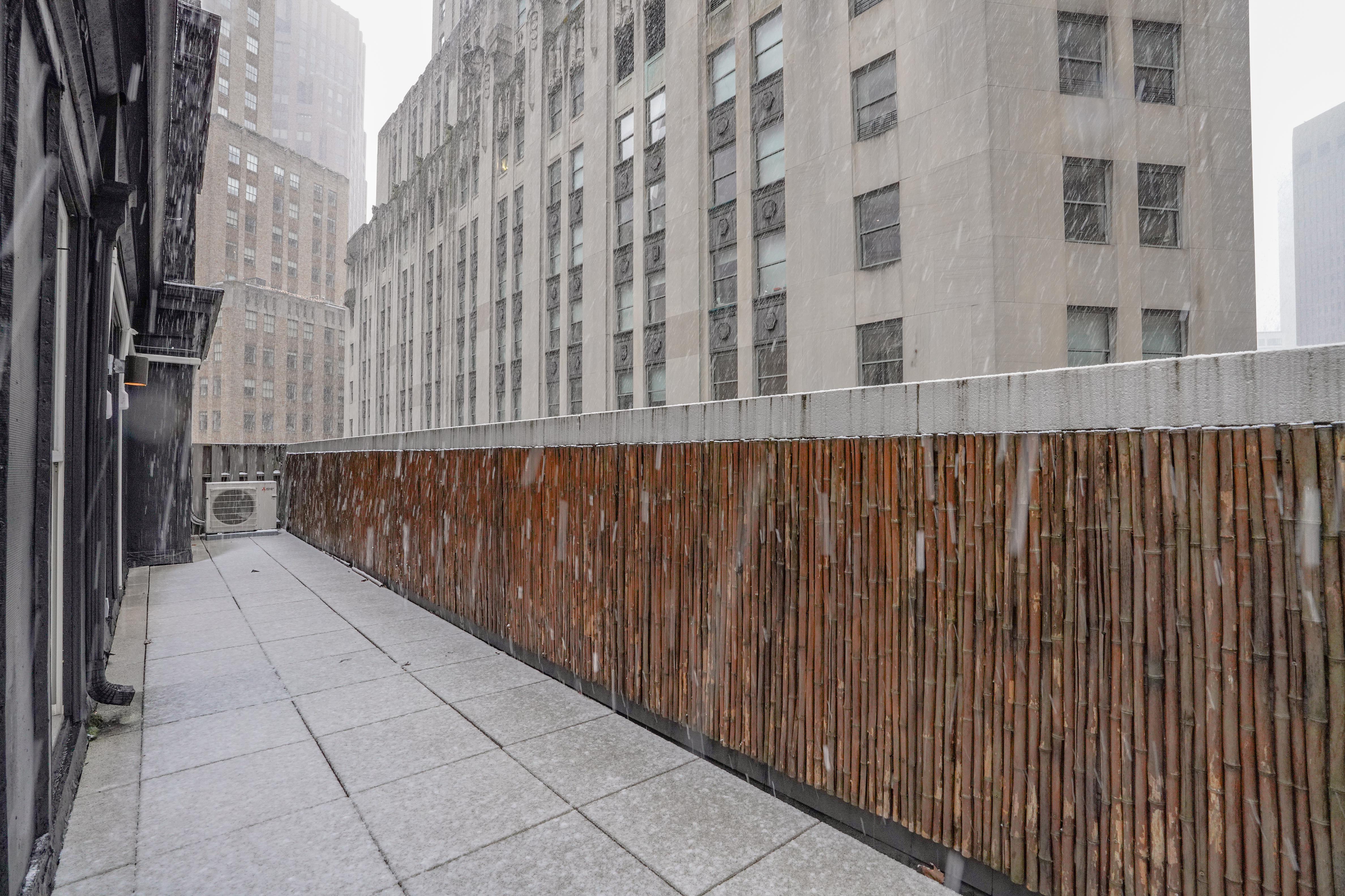 55 Wall Street, Unit PH910 Manhattan, NY 10005 - Photo 5 of 19 a view of a balcony with wooden fence