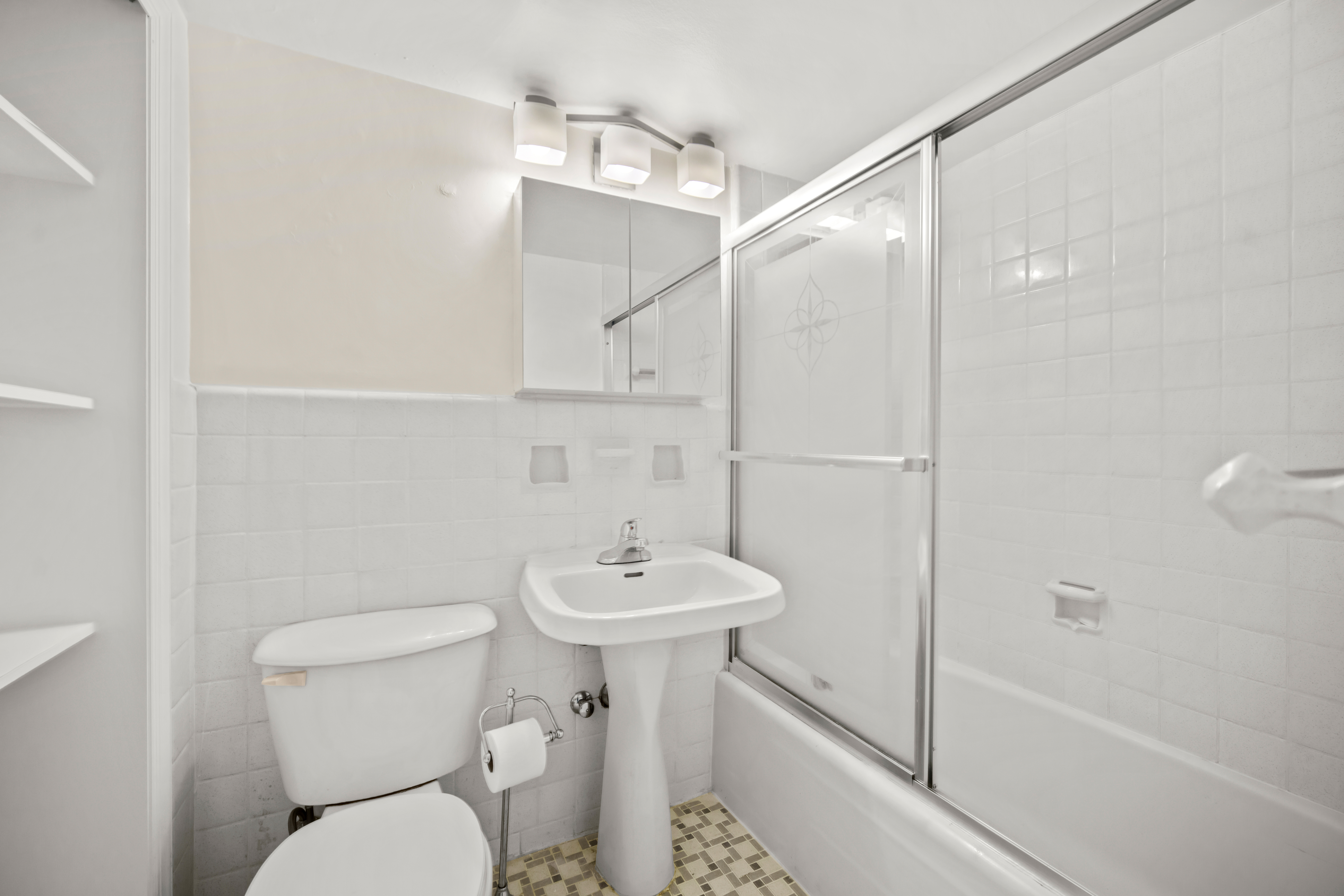 210 East 63rd Street, Unit 5B Manhattan, NY 10065 - Photo 5 of 6 a bathroom with a toilet sink and shower