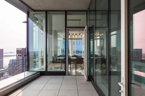 a view of a balcony with floor to ceiling window
