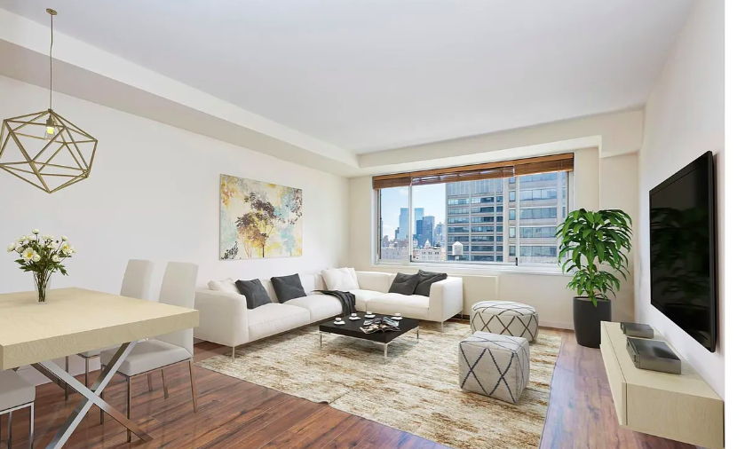 a living room with furniture potted plant and a flat screen tv