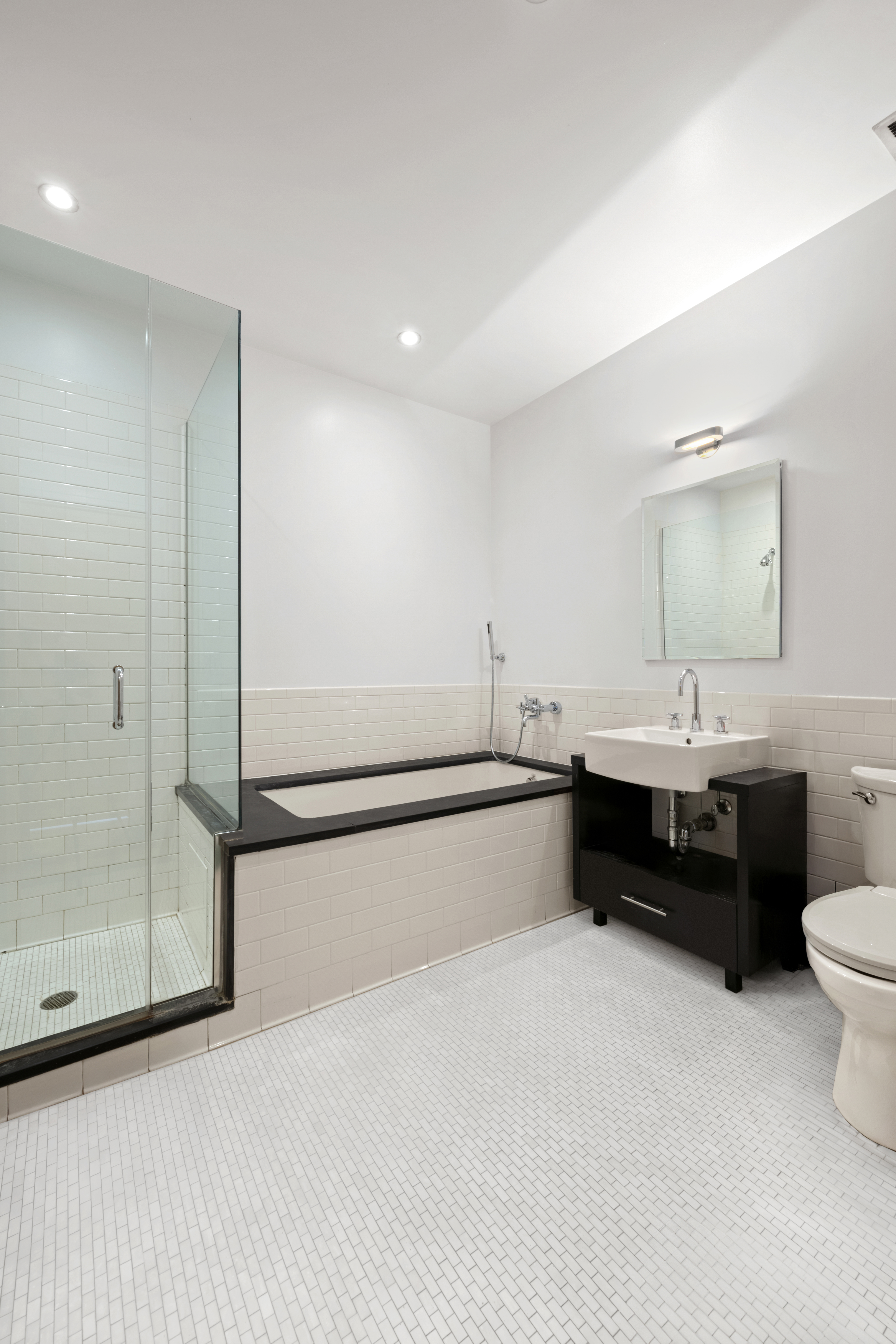 110 Livingston Street, Unit PHL Brooklyn, NY 11201 - Photo 6 of 11 a bathroom with a double vanity sink a mirror and a bathtub