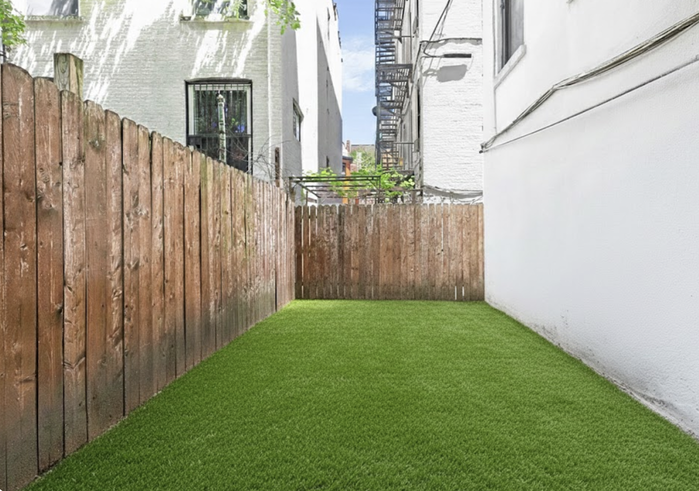 408 8th Avenue, Unit 1C Brooklyn, NY 11215 - Photo 2 of 13 a view of a backyard with wooden fence